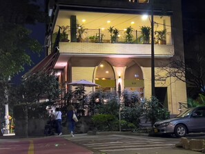 Stunning two-story building with a welcoming entrance and a balcony above.