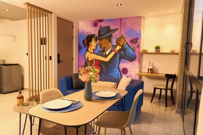 Enjoy a romantic dinner for two in this inviting dining area, complete with a beautiful mural and comfortable seating.