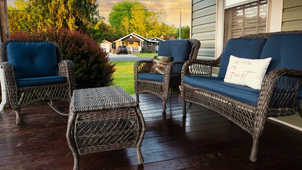 A porch with wicker furniture and a cushion with "BE OUR Guest" text. - Tranquil TN Escape! Book Your Stay In Elizabethton (Elizabethton)