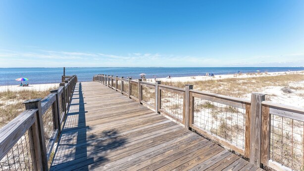 A wooden boardwalk leading to a beach with sand dunes and a clear blue sky. - 5BR WindMark Beach Bunk Room, Pools, Golf Cart, Ping Pong  (Port St. Joe)