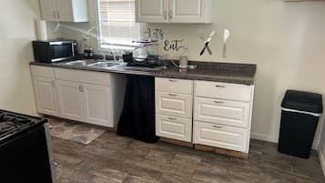 Fridge, microwave, stovetop, cookware/dishes/utensils