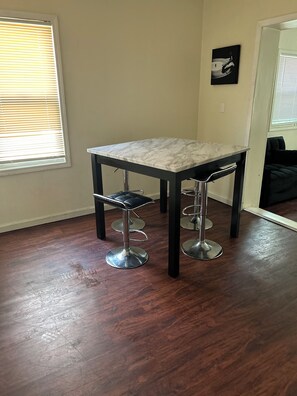 Enjoy meals in this dining area with a table and four chairs.