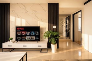 Una sala de estar moderna con un televisor de pantalla plana mostrando la interfaz de Netflix, una planta en maceta y un mueble de entretenimiento elegante.