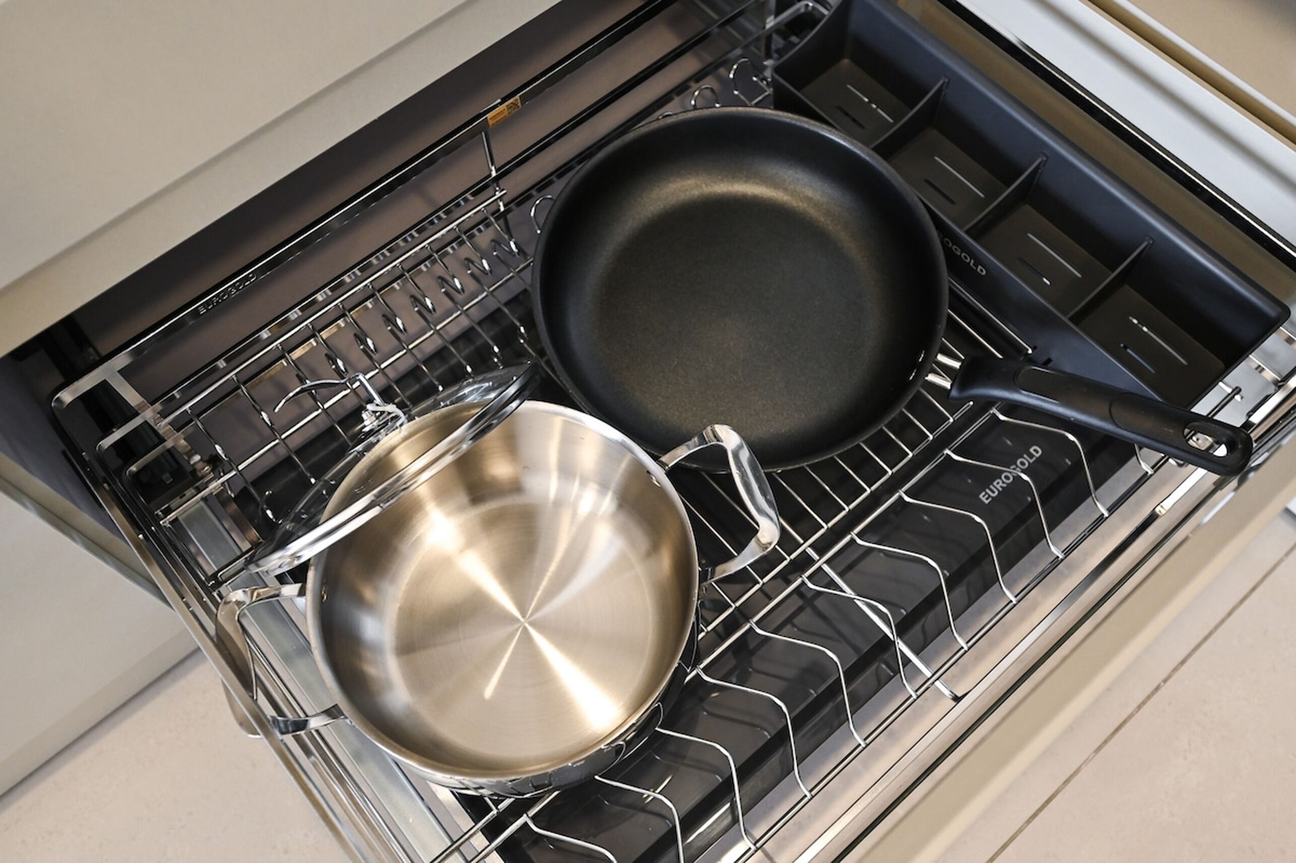 Une cuisine équipée d’une cuisinière et de deux casseroles.