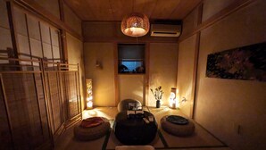 A traditional Japanese room with tatami flooring, a shoji screen, a hanging lamp, and a small window with a view. - NOT A HOME Kameari Station 5 min. walk Free parking Disney Haneda Airport bus direct 90m2 Tea ceremony experience (葛飾区)