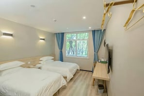 A hotel room with two beds, a desk, a TV, and a window with curtains. - MILA HOTEL (Shanghai)