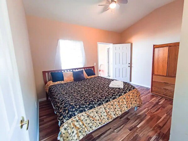 A bedroom with a bed, a ceiling fan, a door, and a wardrobe. - Luxury Ocean-View Villa for Up to 12 Guests - Five Private Bedroom Suites (Esteban Cantu)