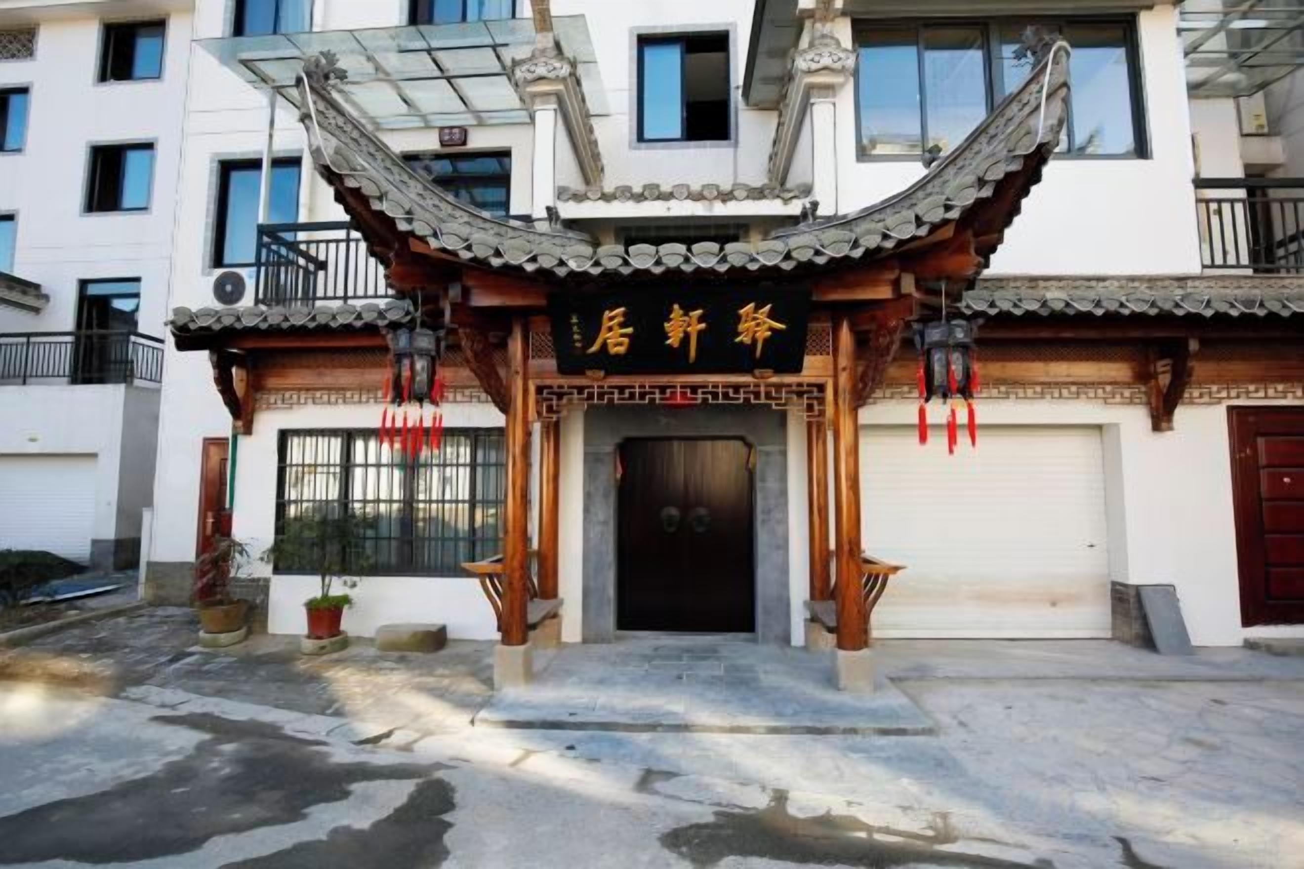 Een traditioneel Chinees gebouw met een pannendak en een zwarte deur.