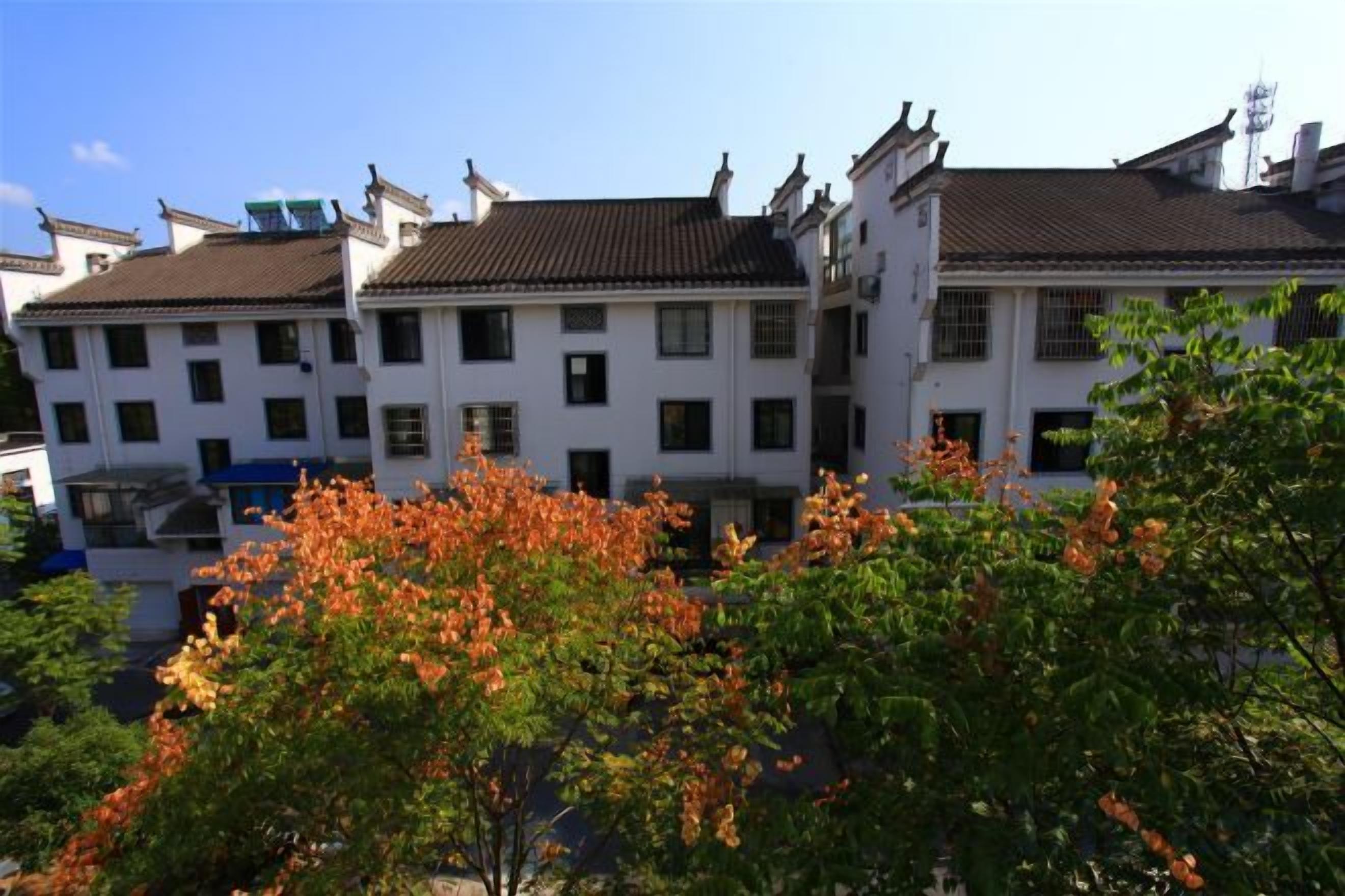 A row of traditional buildings with multiple windows and a clear sky.