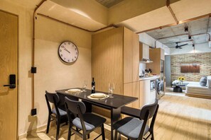 Enjoy meals with family and friends in this spacious dining area, featuring a large table and comfortable seating for four.