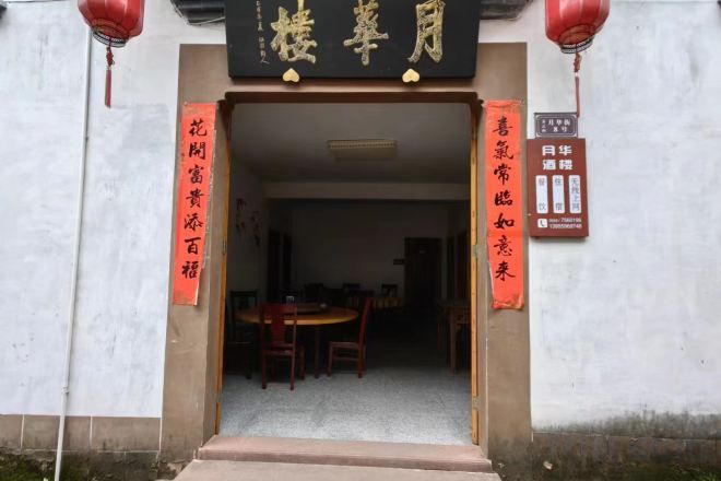 A building entrance with a signboard and a table inside.