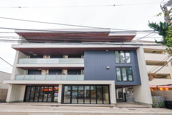 A modern two-story building with a flat roof, large glass windows, and a covered entrance. - Pacific Coast Enoshima by Tranova (Fujisawa)