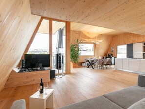 A modern loft with a dining area, kitchen, and entertainment space. - Luxury penthouse near centre, sauna and ski bus (Wörgl)