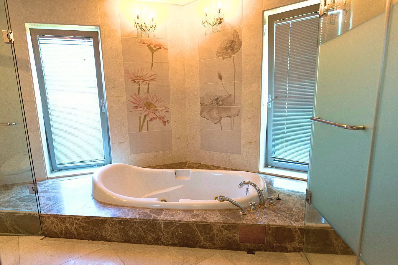 A bathroom with a freestanding bathtub, a shower, and a vanity with a mirror.