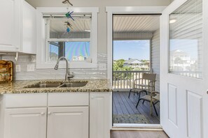 Enjoy a kitchen with a sink, granite countertop, and a window overlooking the neighborhood.