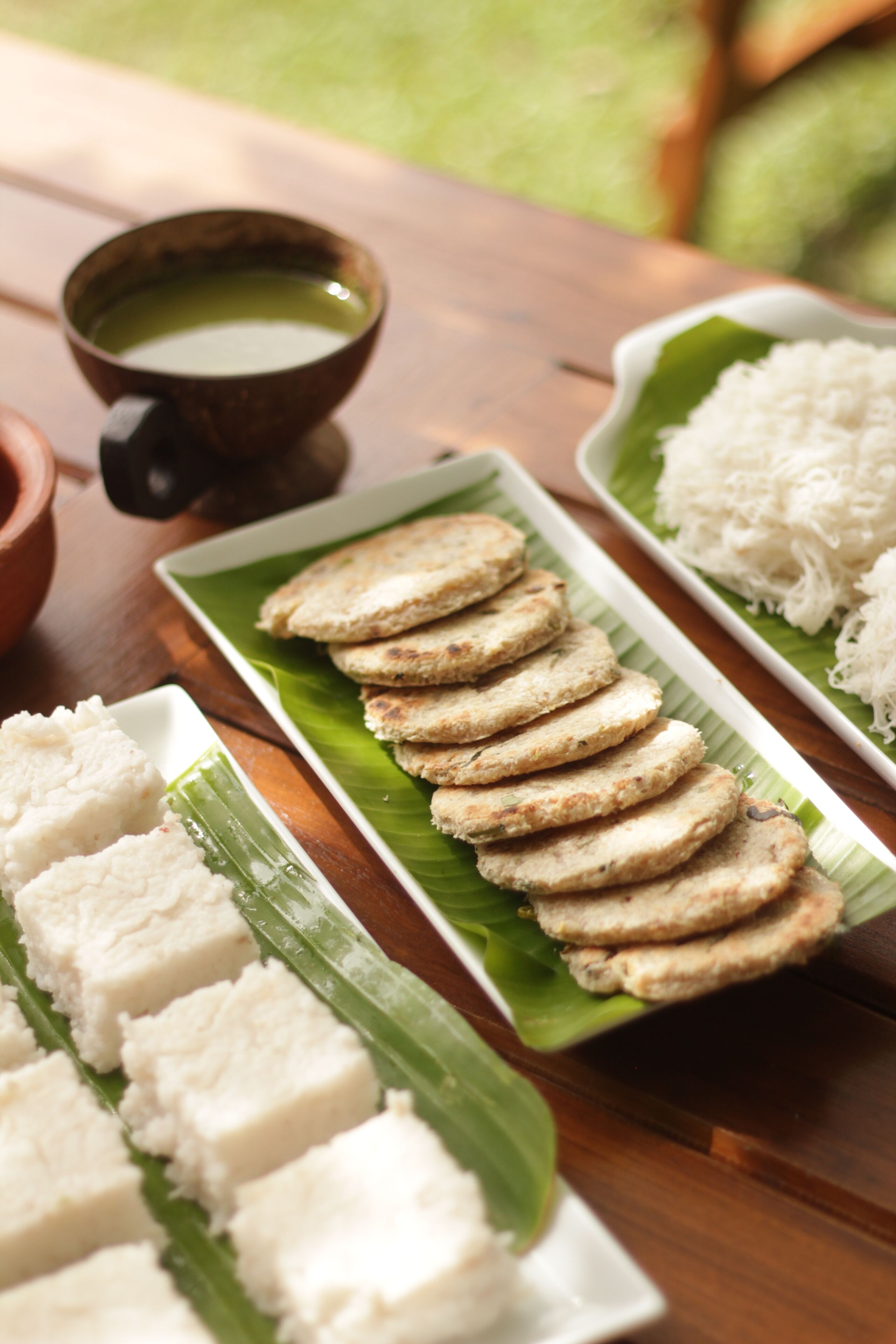 A table with food items including rice, a cup of tea, and a plate with what appears to be fried snacks.