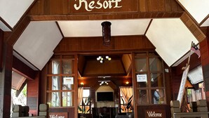 The entrance of Shari-La Island Resort with a wooden facade, a reception desk, and a staircase leading inside. - shari-la Perhentian Island Resort (Pulau Perhentian Kecil)