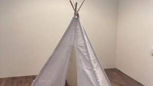 A room with a white teepee tent in the corner, wooden flooring, and a white wall. - Leo66 Guesthouse  (Muar)