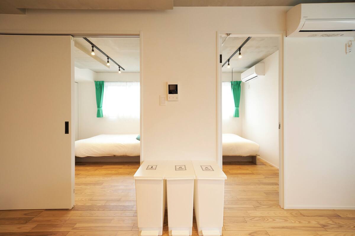 A room with a bed, a mirror, and a white cabinet.