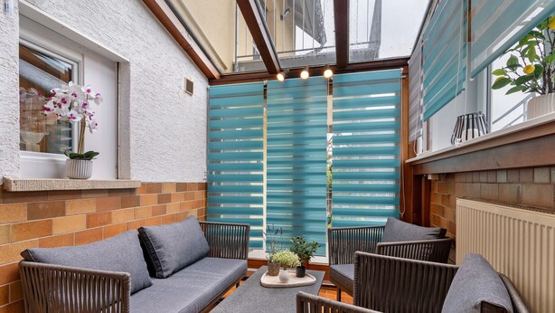 A cozy patio with a sofa, chairs, and a small table. - Holiday Apartment 'Fewo unter der Kirche' with Wi-Fi (Herbolzheim)