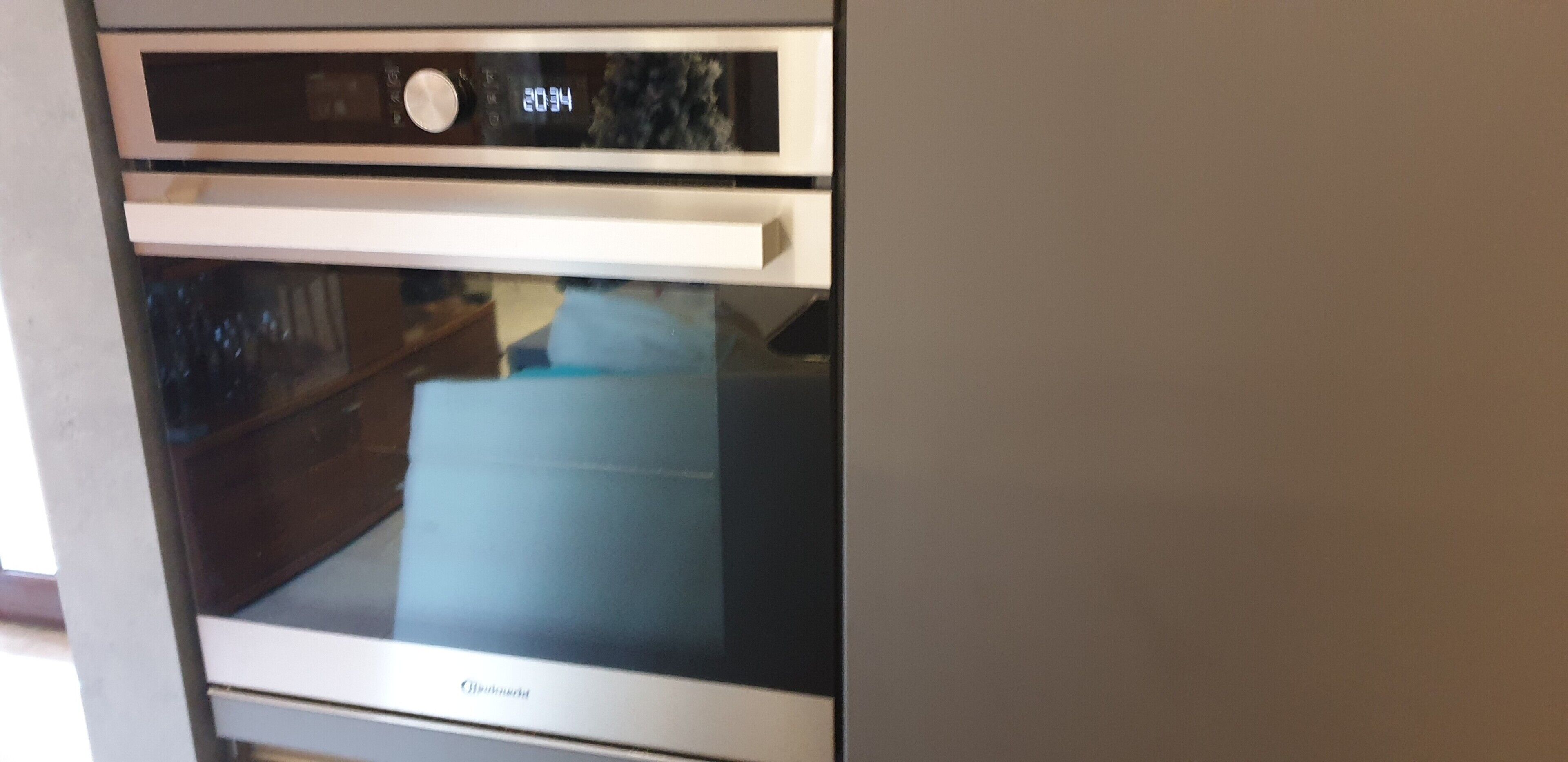 A kitchen with a built-in oven and microwave.