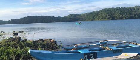 A calm lake with several boats docked at the shore.