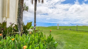 A grassy area with a building on the left and a clear sky. - Ocean and Pool Views! Steps To Beach, Stroll to Restaurants, Shops, and Pier, $300 in Free Tickets! (St. Augustine)