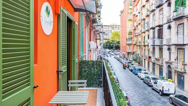 A narrow street with parked cars and buildings on either side. - Lo Spagnoletto (Naples)