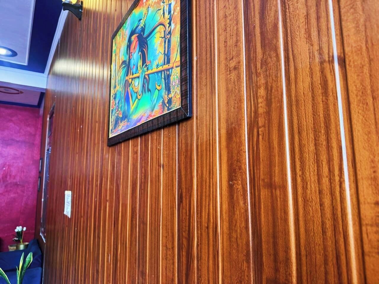 A wooden wall with a framed artwork.