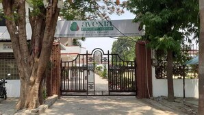 A gated entrance to Avexia Fun City Resort with a signboard indicating amenities like a conference hall, pool, and restaurant. - Avexia Funcity Resort (Mirzapur)