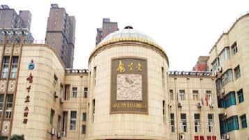 A building with a prominent dome and signage indicating 'JINGYU TANGHOU' and 'JINGYU TANGHOU HOTEL'.