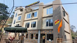 A multi-story building with a sign reading "RAJASTHAN DHANI". - Rajasthani Hotel Dhani (Sonapur)