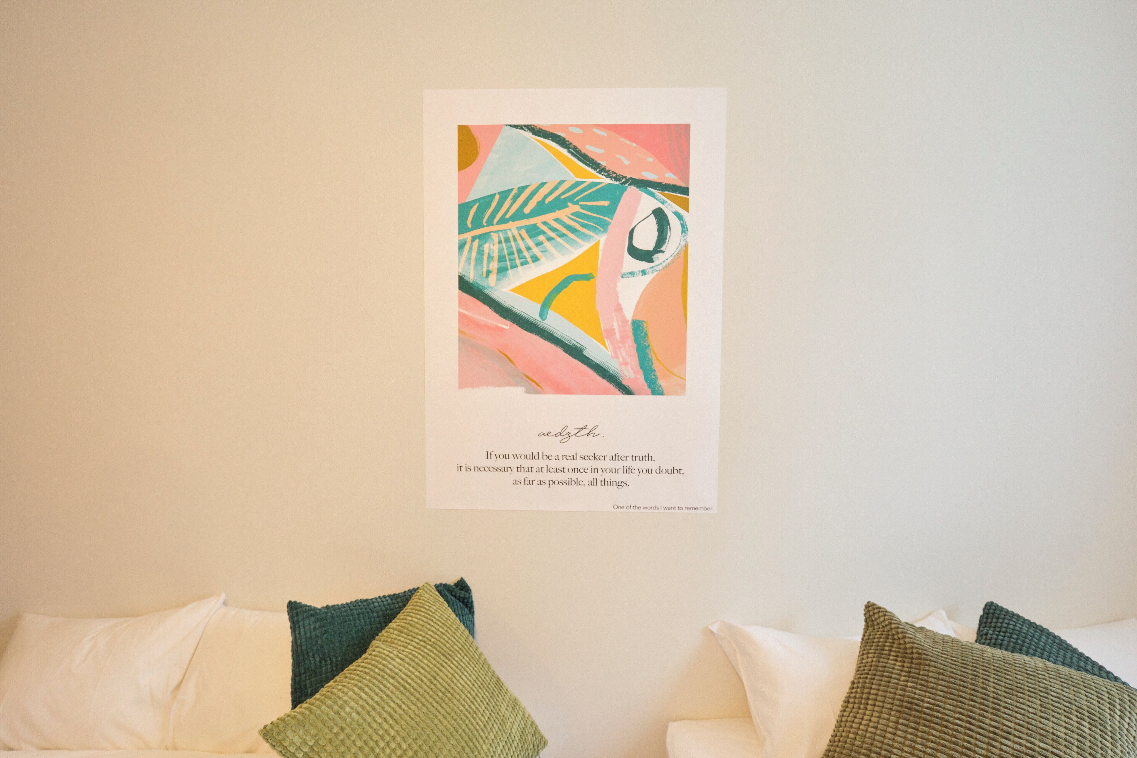 A framed artwork on a wall with a quote below it.
