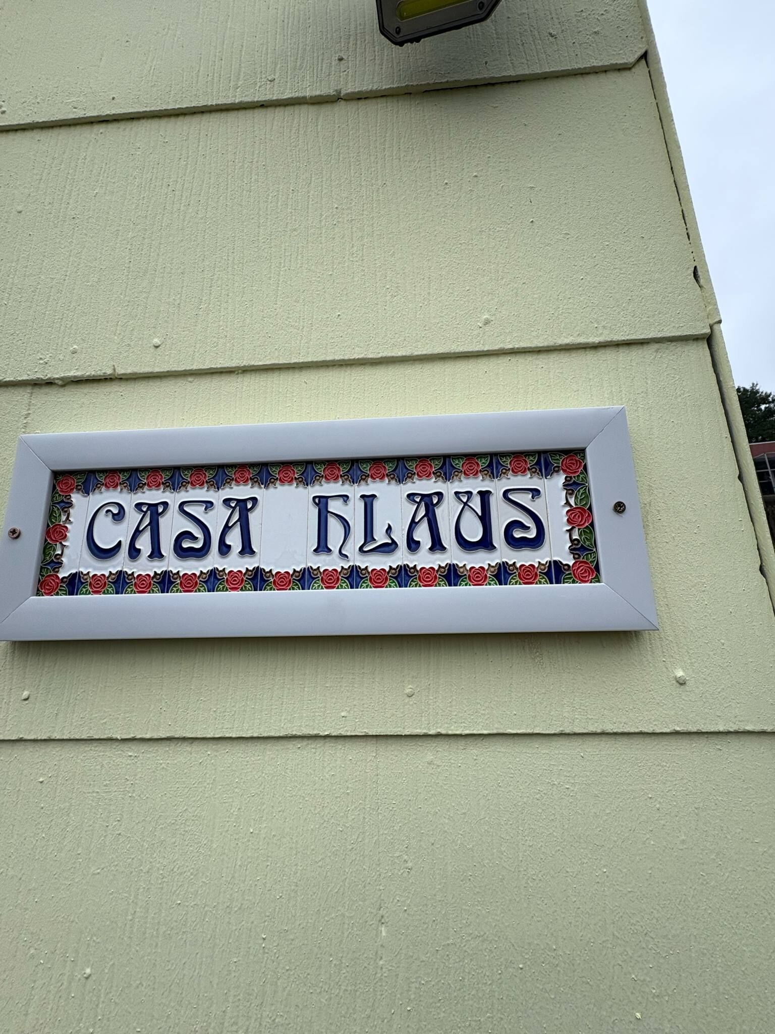 A house nameplate on a building.