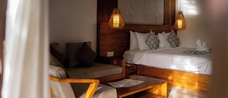 A bedroom with a wooden bed, a wooden nightstand, a wooden chair, and a wooden coffee table.