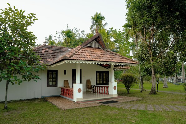 A small, single-story house with a tiled roof and a porch. - Palmgrove Lake Resort (Ambalapuzha)