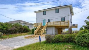 A two-story house with a wooden staircase leading to a deck. - The Black Pearl - Oceanfront - North Topsail (North Topsail Beach)