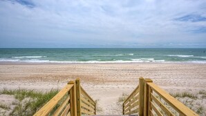 A wooden boardwalk leading to a sandy beach with the ocean in the background. - The Black Pearl - Oceanfront - North Topsail (North Topsail Beach)
