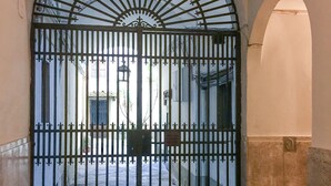 A wrought iron gate with a semi-circular top, set within an arched doorway. - Maggio 54 in Florence (Florence)