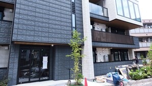 A modern building with a stone facade and multiple balconies. - Grand Grace Zoshiki by Tranova (Tokyo)
