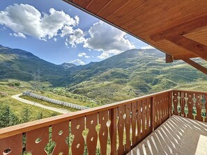 Enjoy breathtaking views of the surrounding mountains from this balcony.
