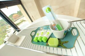 A tray with a white mug, a green cup, and three green tubes on a blue coaster with a starfish design. - Grand New Century Resort Dongtou Wenzhou (Wenzhou)