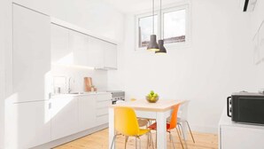 A modern kitchen with white cabinets, a wooden countertop, and a dining table with two chairs. - 2 Classic Apartments by HostWise (Porto)