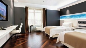 A hotel room with two beds, a desk, a chair, and a TV. - Qinhuangdao Haishanghai International Hotel (Qinhuangdao)