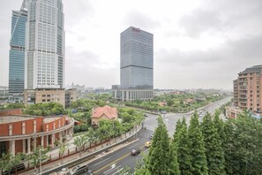 A cityscape with modern high-rise buildings, a curved road, and greenery. - iNestin Shanghai (Hongfeng Road) (Shanghai)