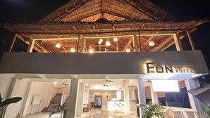 A hotel with a thatched roof and a sign reading "Fun Hotel." - Fun Hotel (Panglao Municipality)
