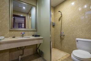 A bathroom with a sink, mirror, shower, and toilet. - Chonpines Hotel (Xinyu)