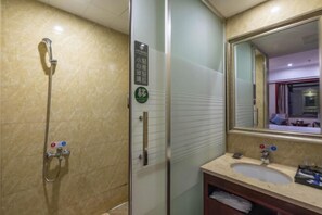 A bathroom with a glass shower enclosure, a sink with a mirror, and a towel rack. - Chonpines Hotel (Xinyu)