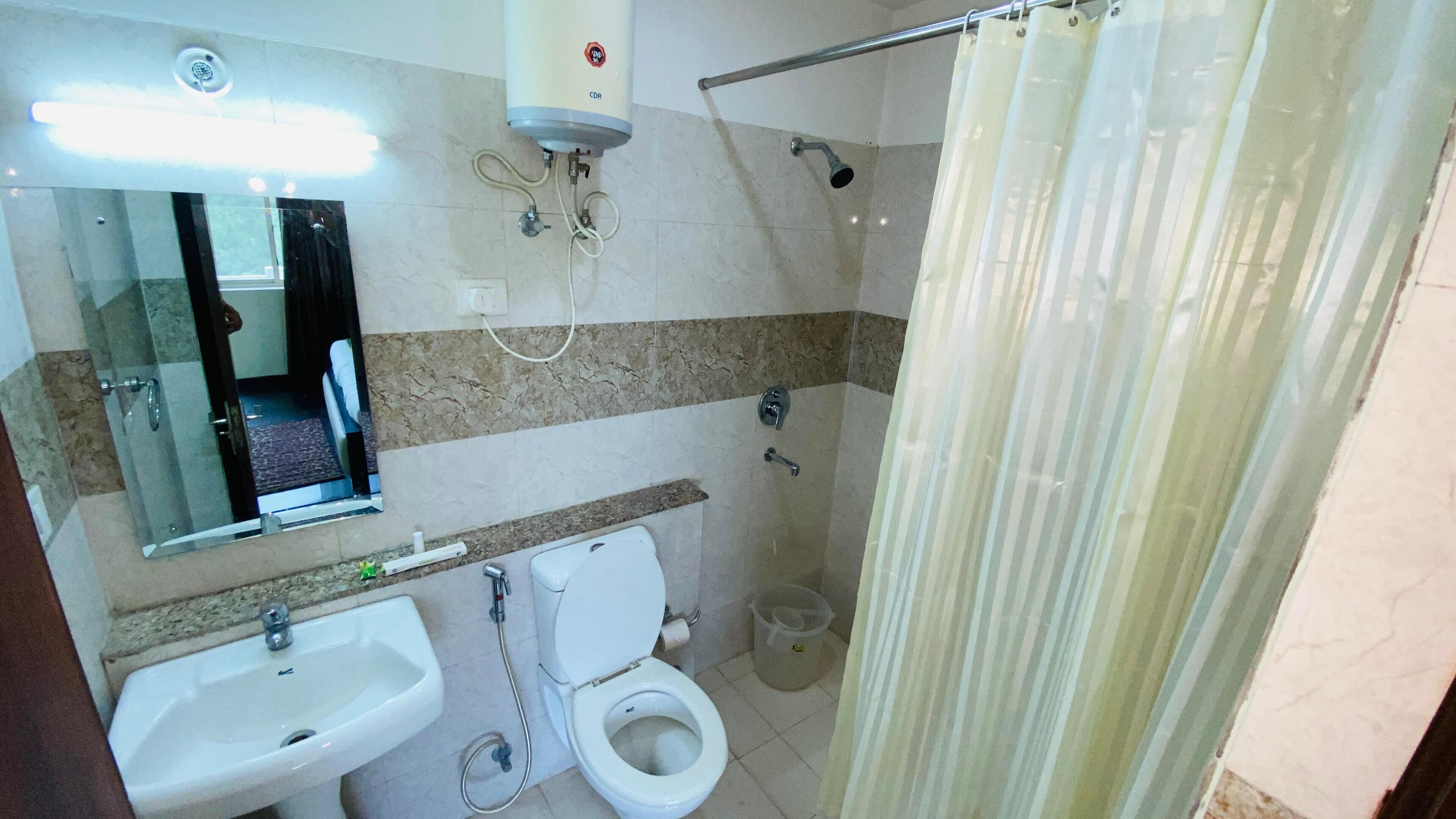 A bathroom with a sink, toilet, and shower.