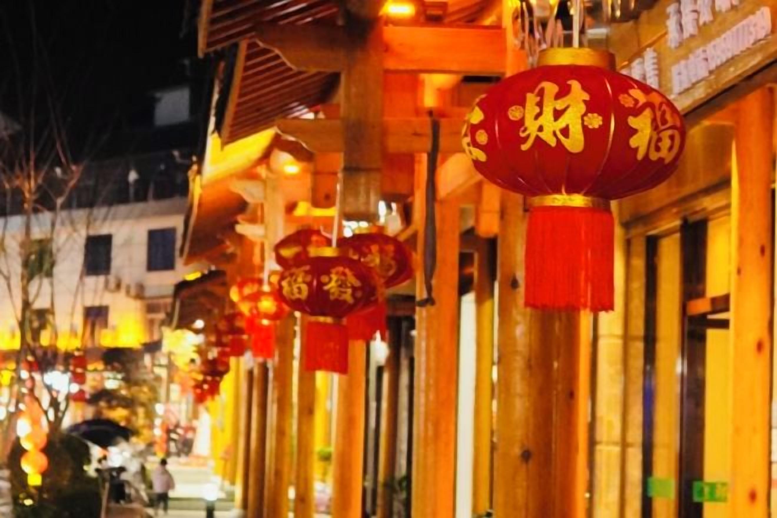 A row of buildings with traditional architecture and red lanterns.